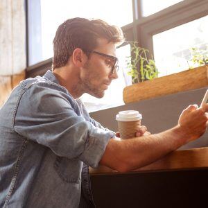 Man Coffee drinking smartphone